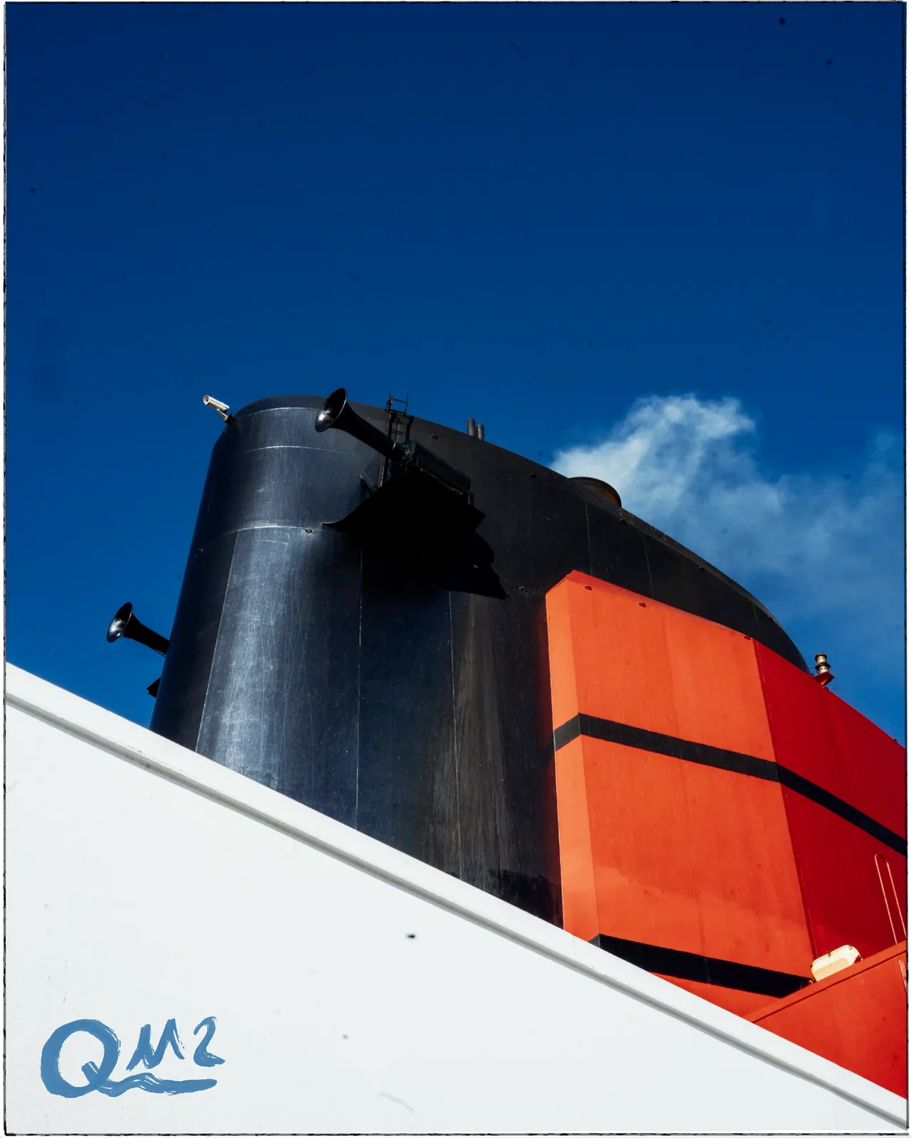 The black and red funnel of Queen Mary 2 against a deep blue sky, set in a hand-drawn black frame with a monogram mark
